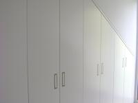 Wandschrank in weiß in einer Dachschräge 